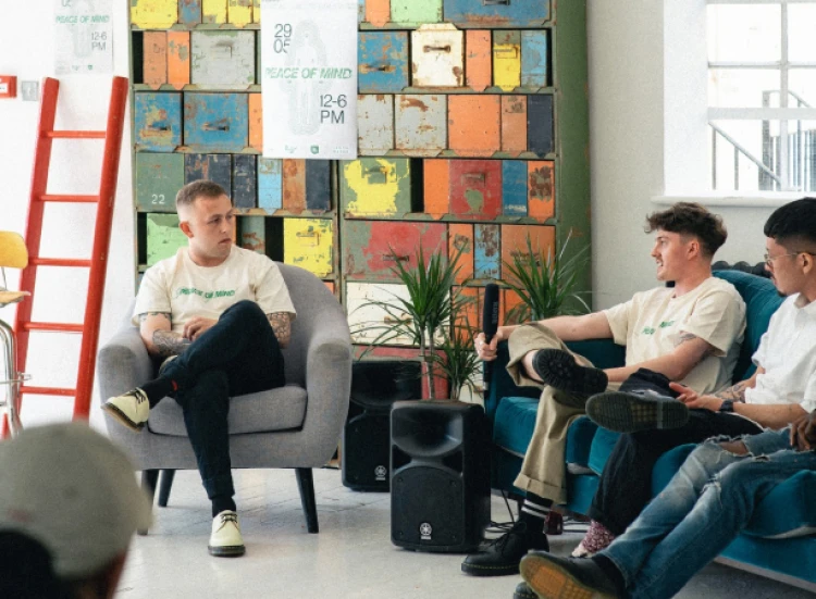 Three people sitting and talking